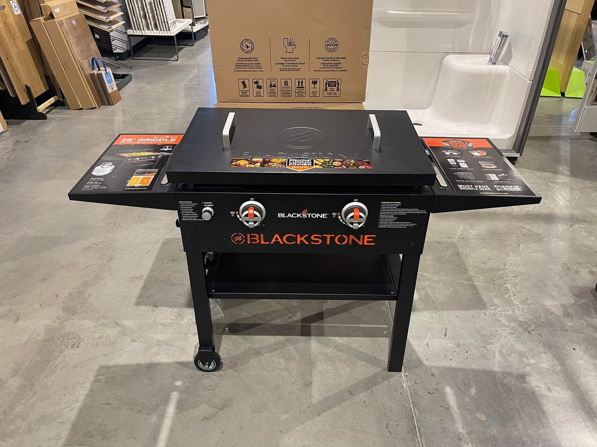 Blackstone flat-top grill on a stand in a warehouse store aisle