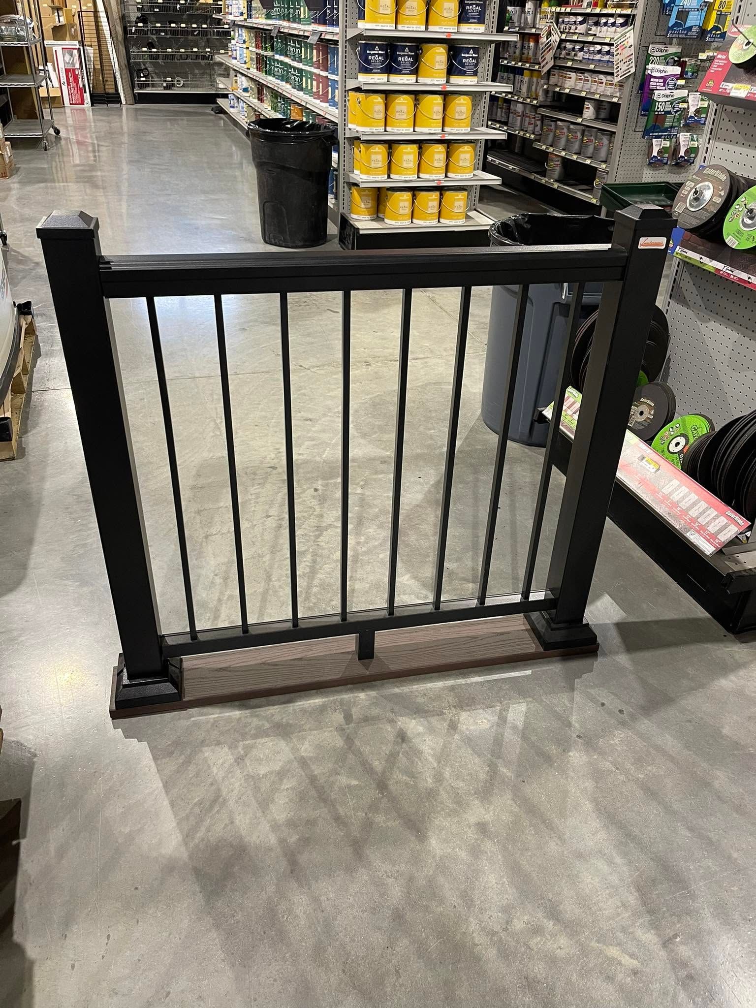 Black metal gate blocking a grocery store aisle between shelves