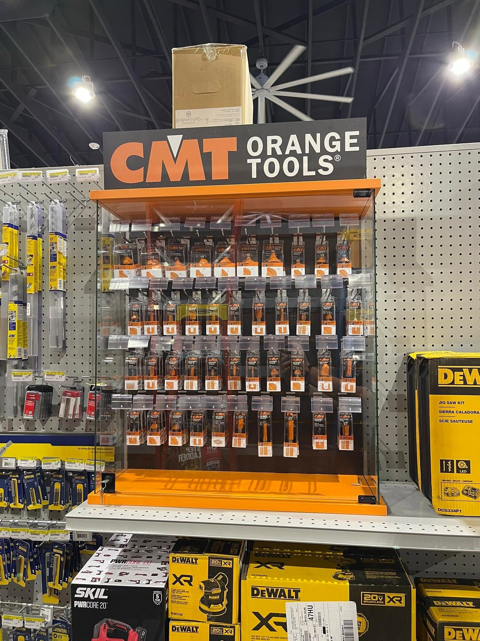 Orange CMT Tools display rack in a hardware store with rows of packaged drill bits and accessories