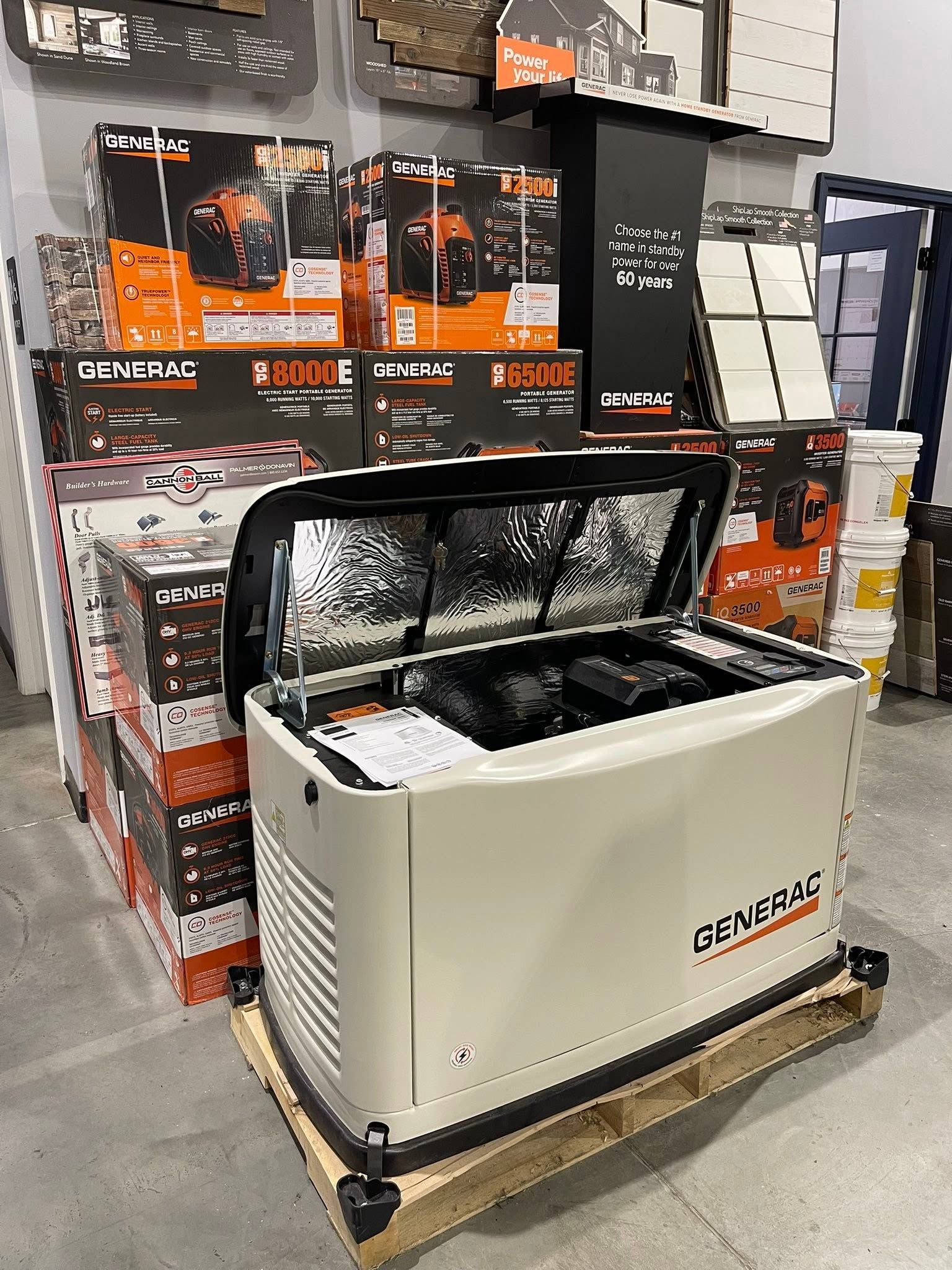 Chest freezer on a pallet in a store aisle, surrounded by boxed products and display signs.