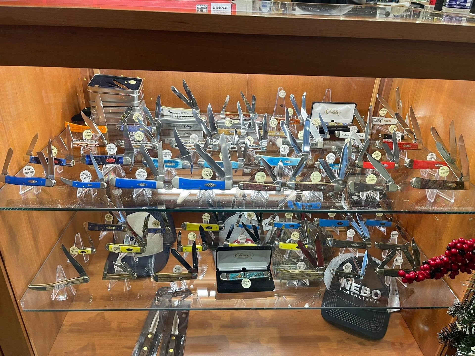 Glass shelves filled with assorted small figurines and collectibles in a display cabinet
