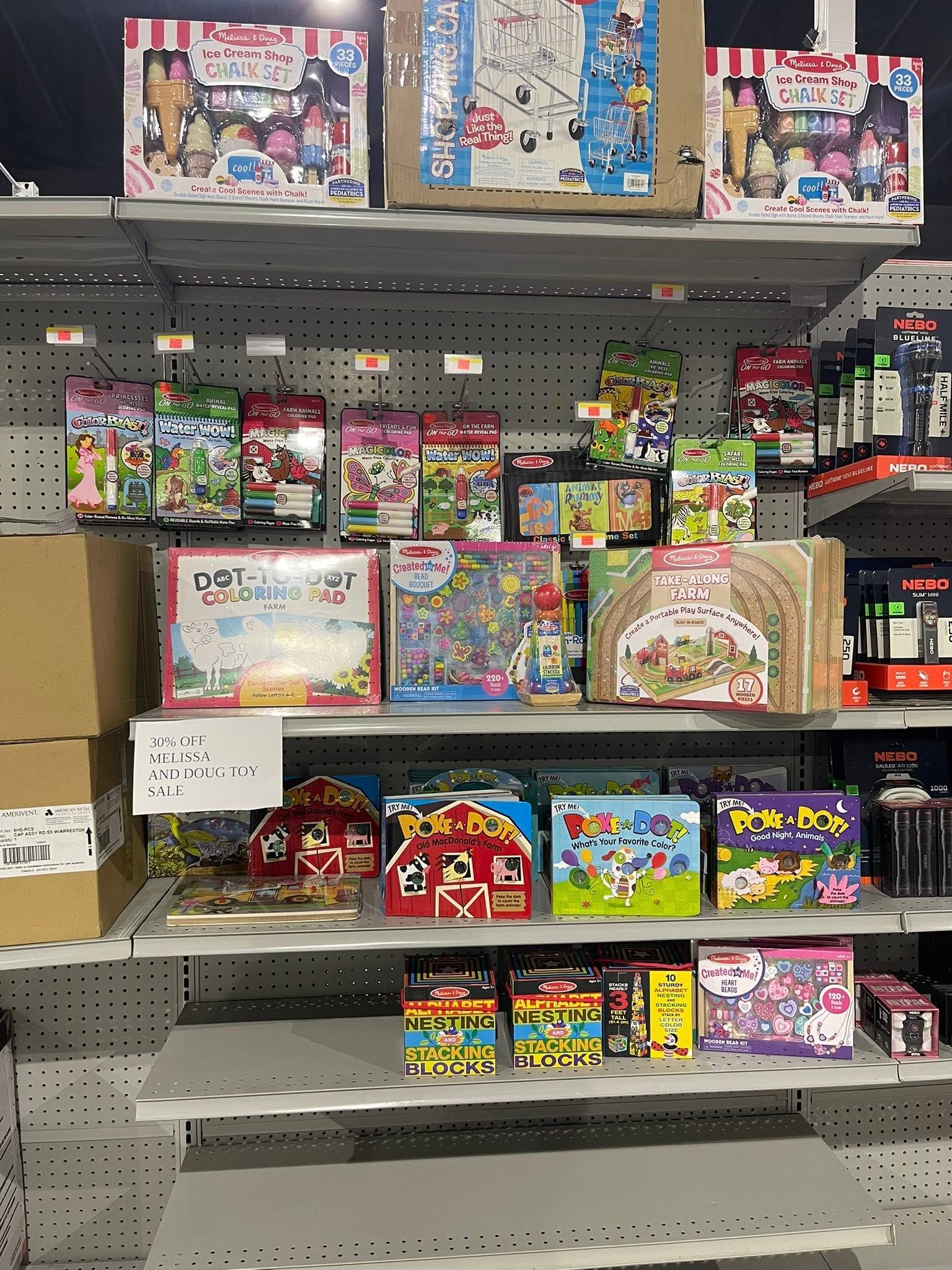 Toy store shelf filled with colorful LEGO and building set boxes