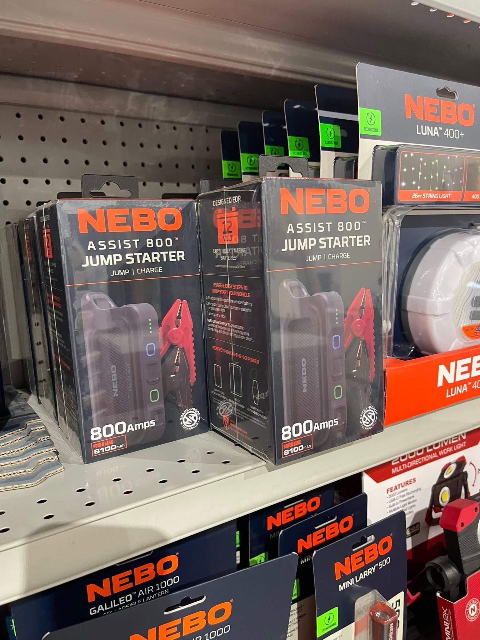 NEBO emergency jump starter boxes on a store shelf, black packaging with orange branding