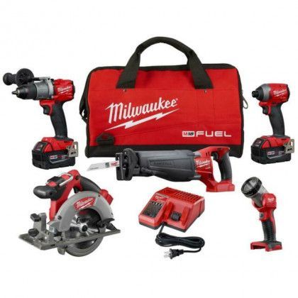 Milwaukee M18 Fuel tool kit with bag, drills, saw, grinder, batteries, and charger on white background
