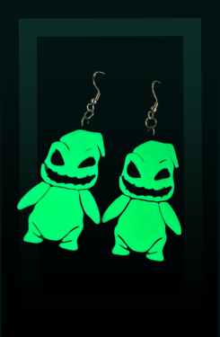 Pair of glow in the dark green Oggie Boogie earrings on a dark background