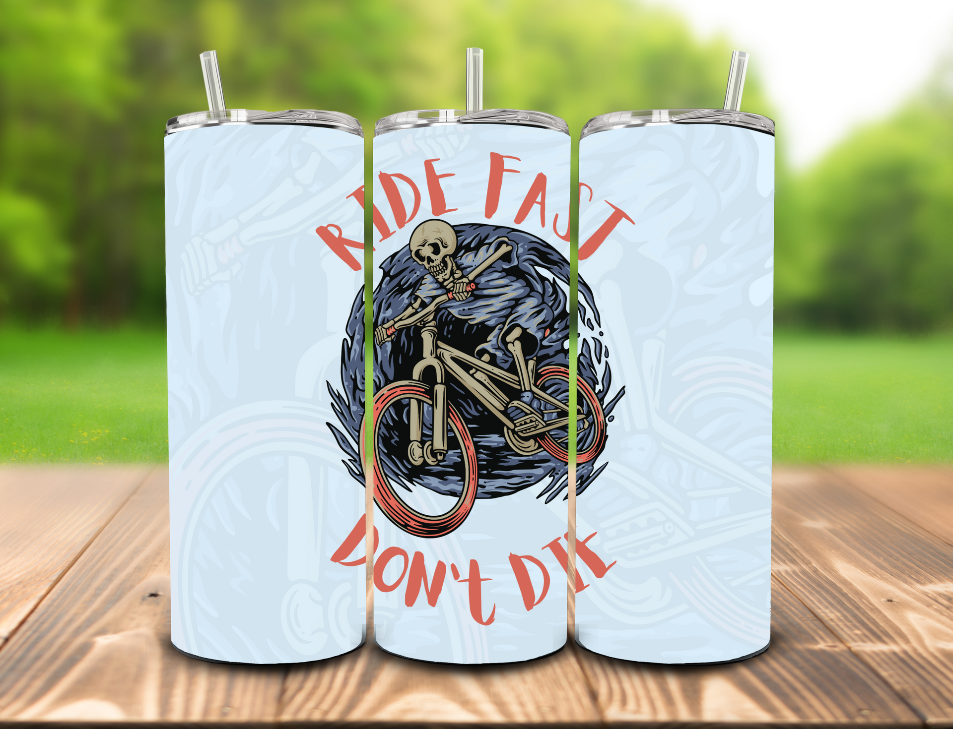 A tumbler featuring a skeleton riding a mountain bike, with the red text 