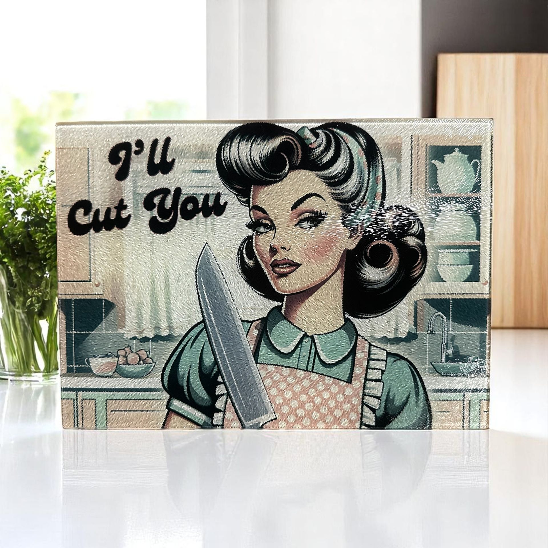 A kitchen cutting board featuring a retro-style illustration of a person in an apron holding a knife, reading 