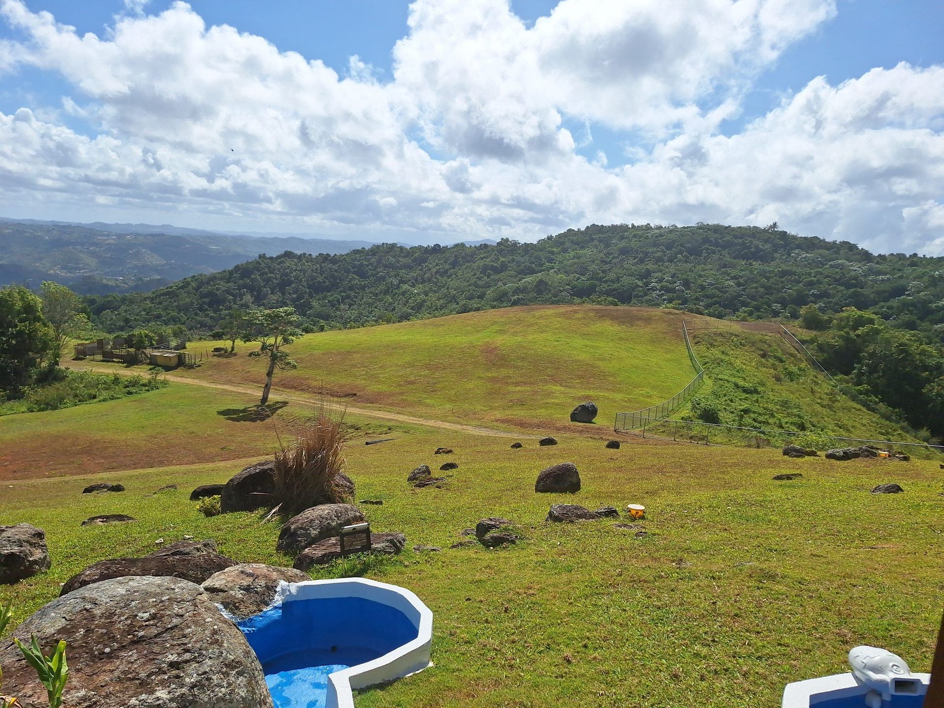 Rolling pasture, boulders and mountain views across a 100-acre estate in Cayey, Puerto Rico