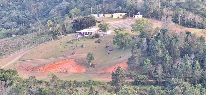 The main residence, pasture and red clay seen from above