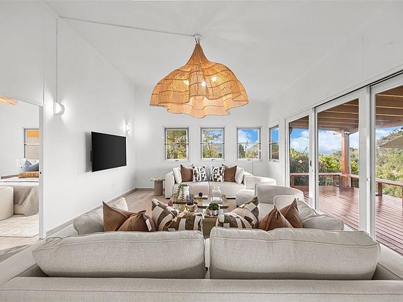 Living room with sofas and valley views through the glass doors