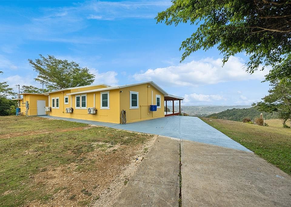 Main residence side view with concrete walkway