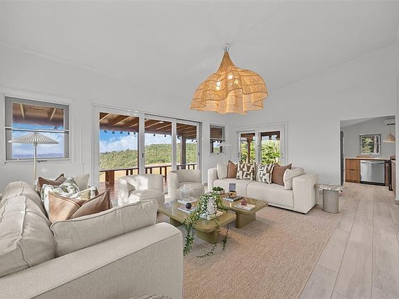 Open living, dining and kitchen in the remodeled main residence