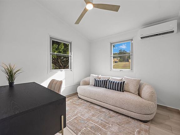Guest room with sofa and ceiling fan