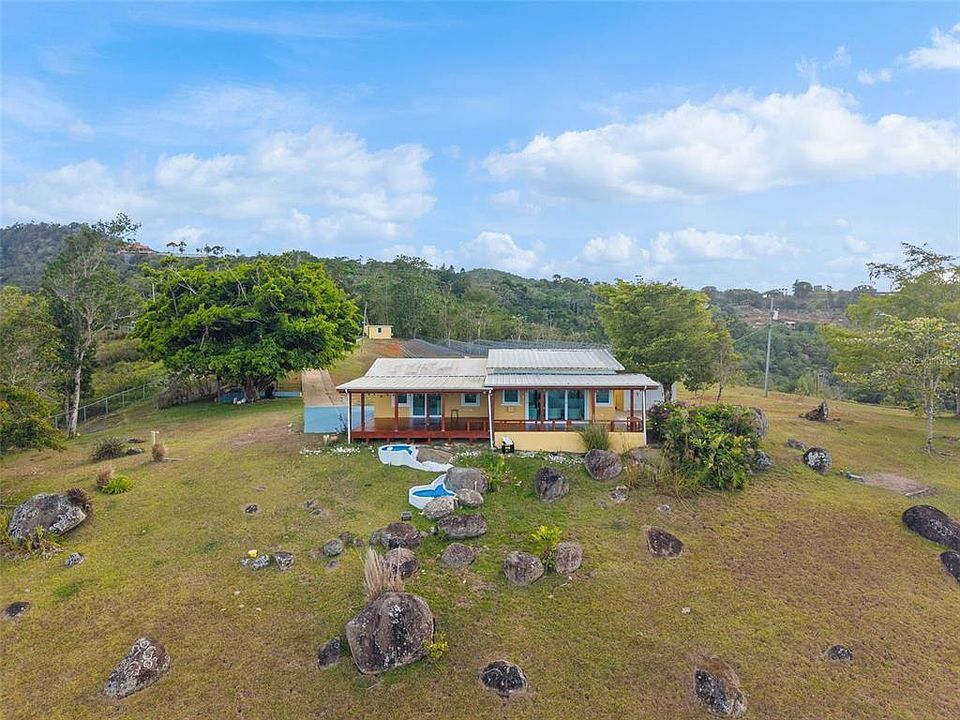 Main residence on its hilltop lawn among boulders