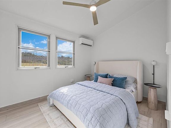 Bedroom with ceiling fan and mini-split air conditioning
