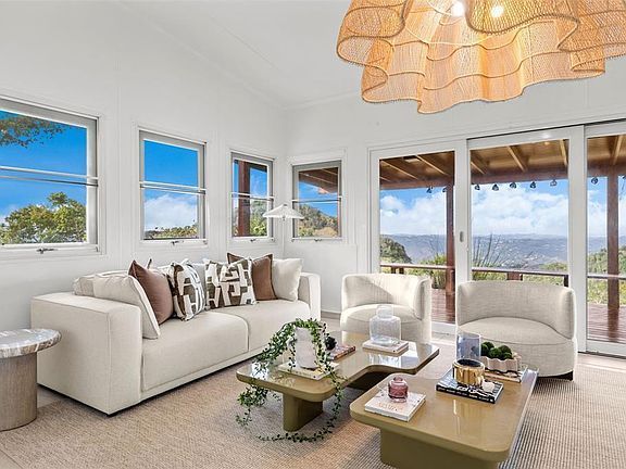 Living room corner with sofa, armchairs and deck view