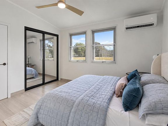 Bedroom with mirrored closet doors