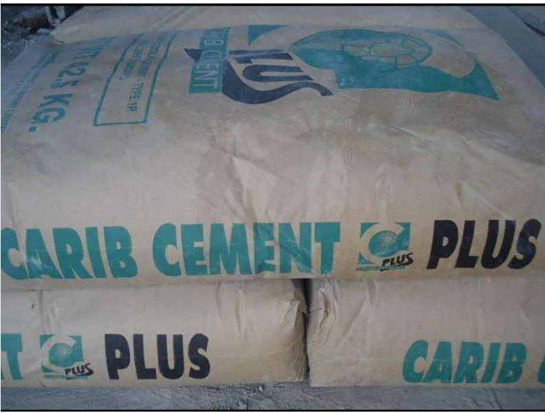 Two bags of carib cement plus are stacked on top of each other