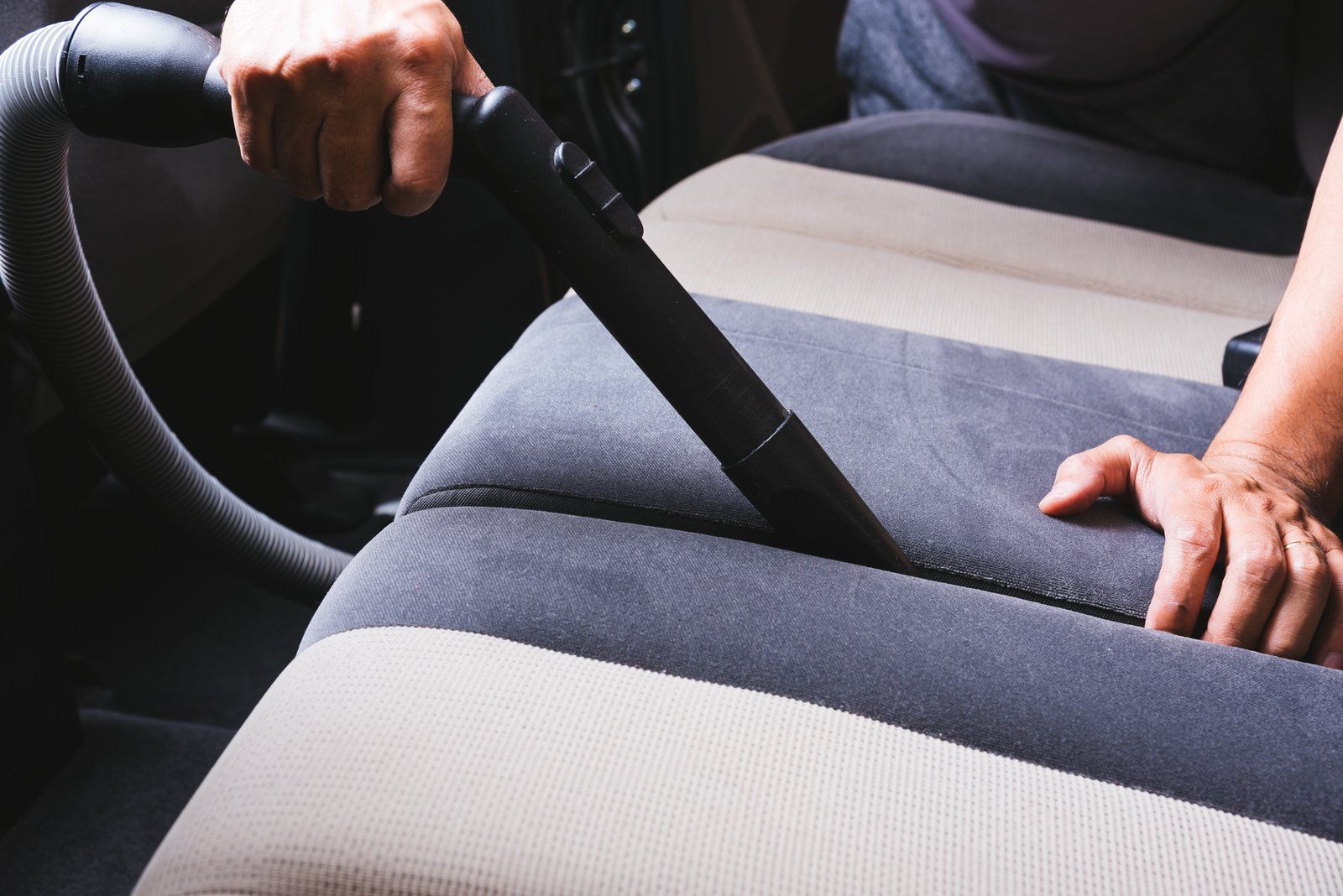 vacuuming the car seat