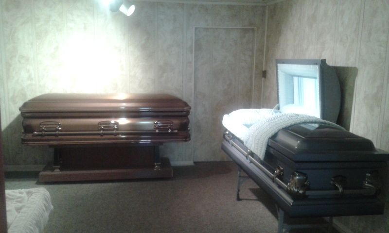 A room with two coffins one of which is open