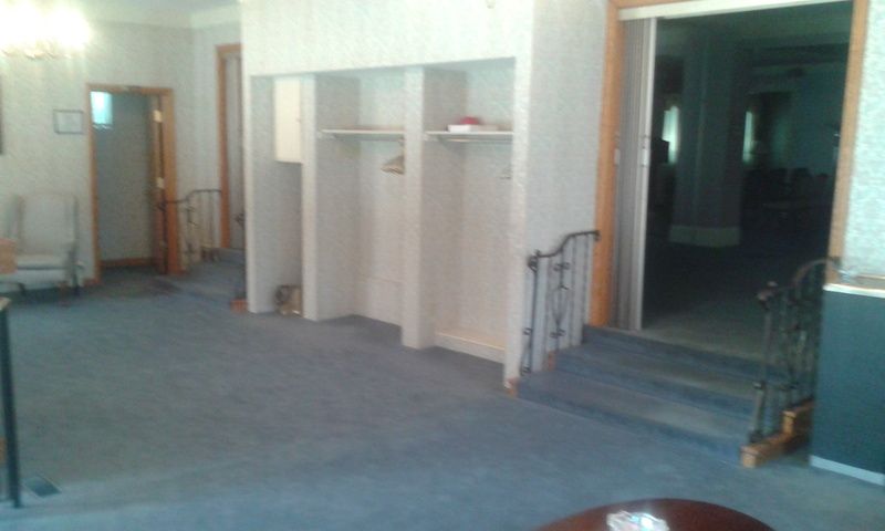 An empty room with a table and chairs in it