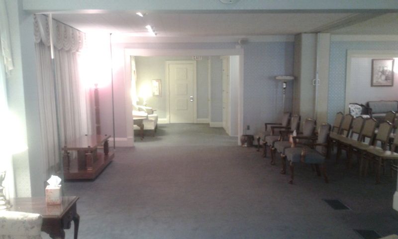 A hallway with a lot of chairs and a table