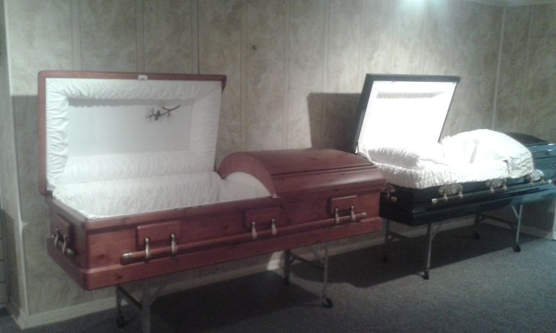 Two coffins are sitting next to each other in a room.