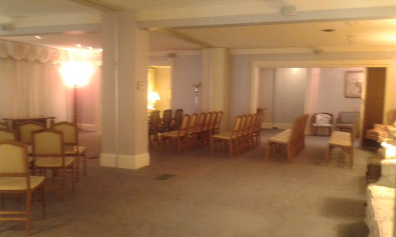 A room with a lot of chairs and a lamp