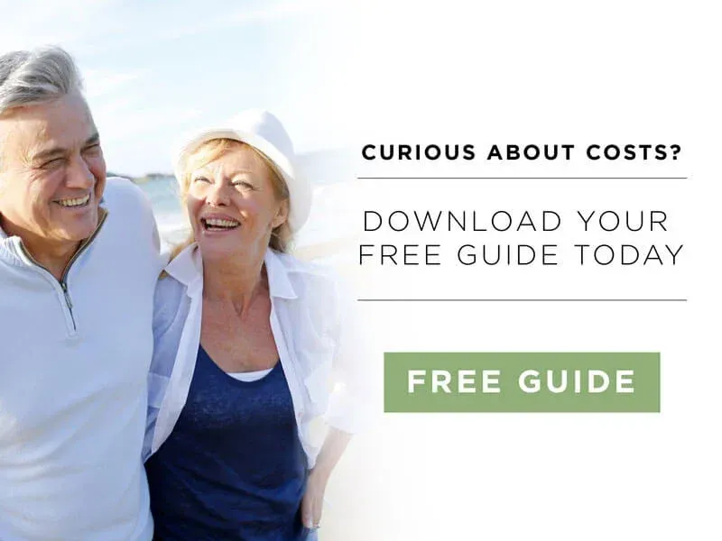a man and a woman are standing next to each other on the beach .