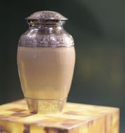 a vase is sitting on top of a wooden box .