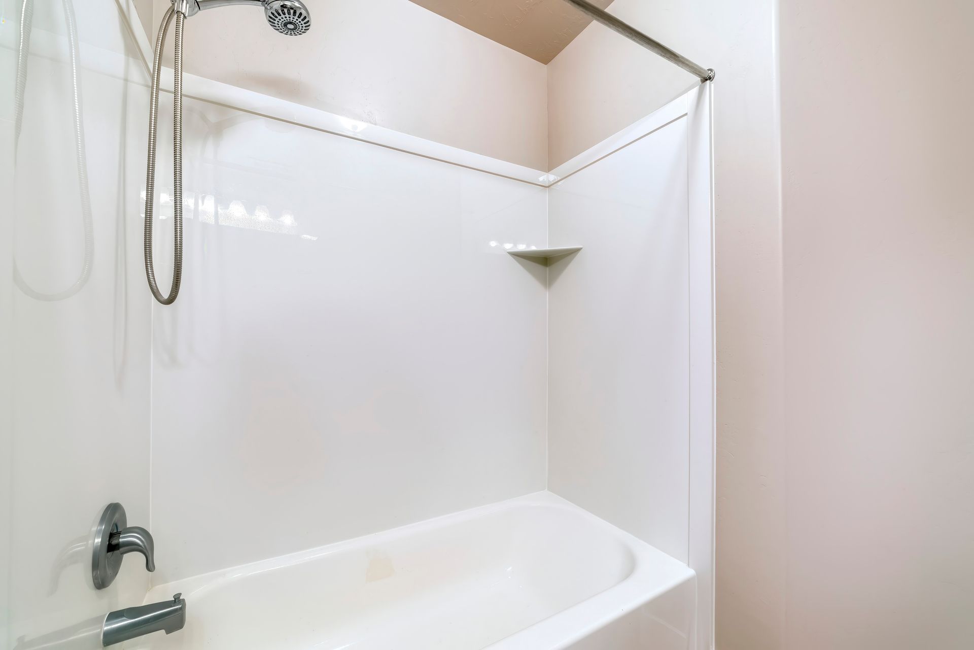 Technician reglazing a bathtub to restore a smooth, glossy finish in a New Jersey home.