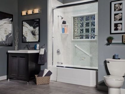 A bathroom with a toilet , sink and bathtub