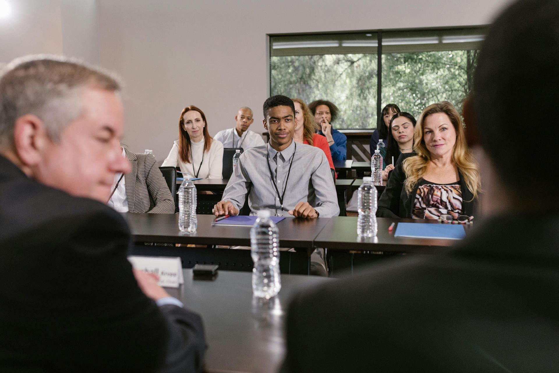 business people listening to panel in a conference room