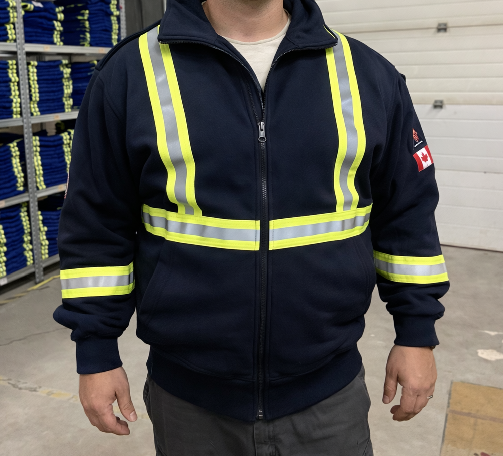 Person wearing a navy blue hooded zip-up sweatshirt with their hand in the pocket, standing near stairs.