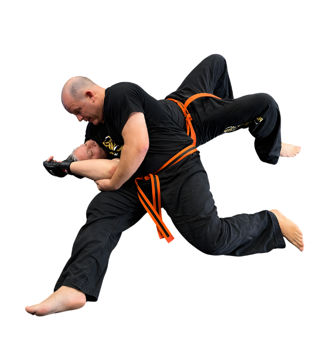 Man pointing, smiling, wearing black hoodie; arm tattoo visible.