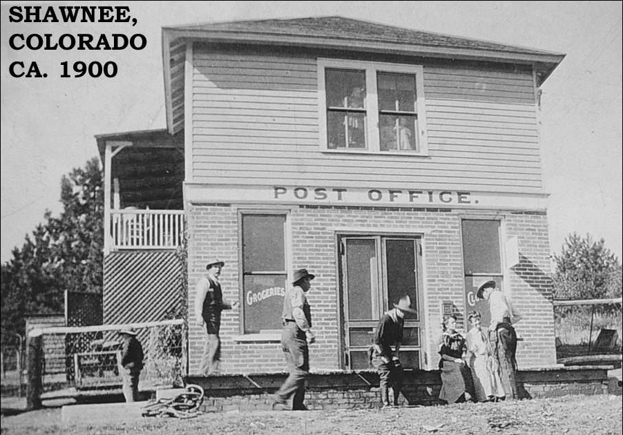 Shawnee, Colorado post office, circa 1900. People outside building, wood siding, sign: