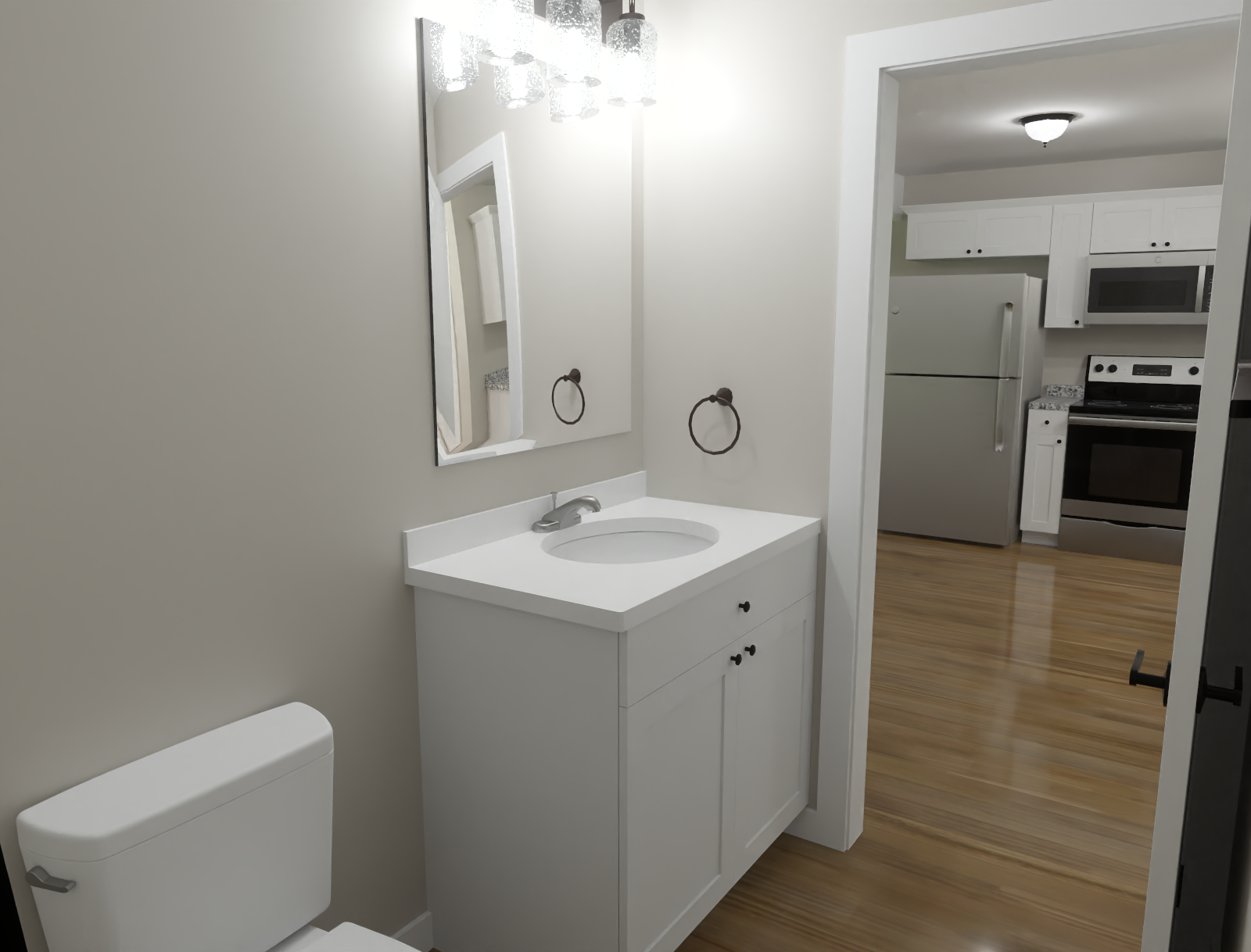 Small white bathroom vanity with mirror and toilet, looking into a kitchen with wood floors.