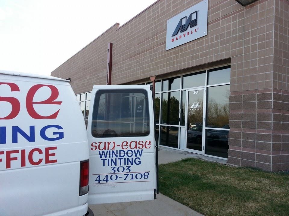 Windshield tinting office storefront with a white van parked outside.