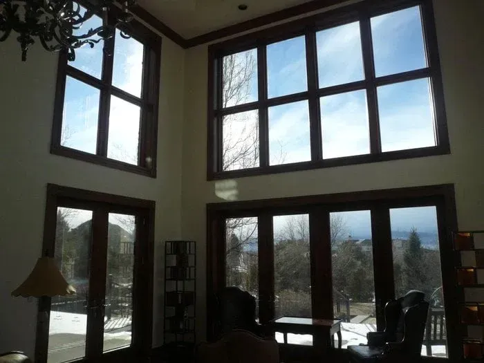Bright living room with tall windows, showing a snowy outdoor view.