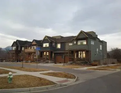 Suburban townhouse complex on a quiet street under an overcast sky
