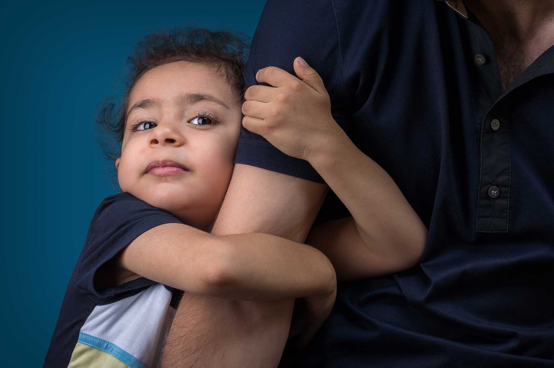 Young Child Clinging to Parent
