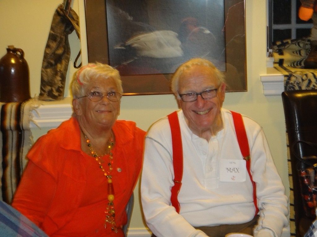 A man with a name tag that says Max sits next to a woman.