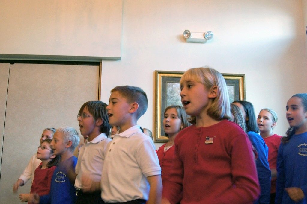 A group of kids are singing together.