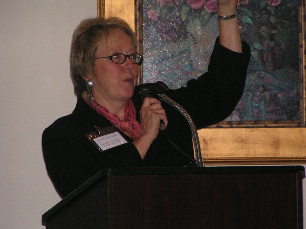 A woman stands at a podium.