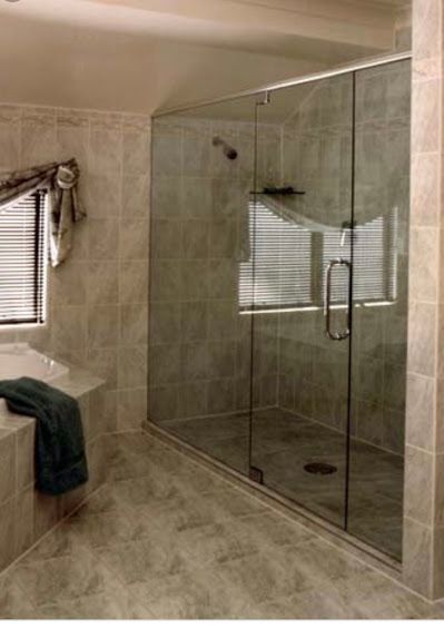 A bathroom with a walk in shower and a bathtub