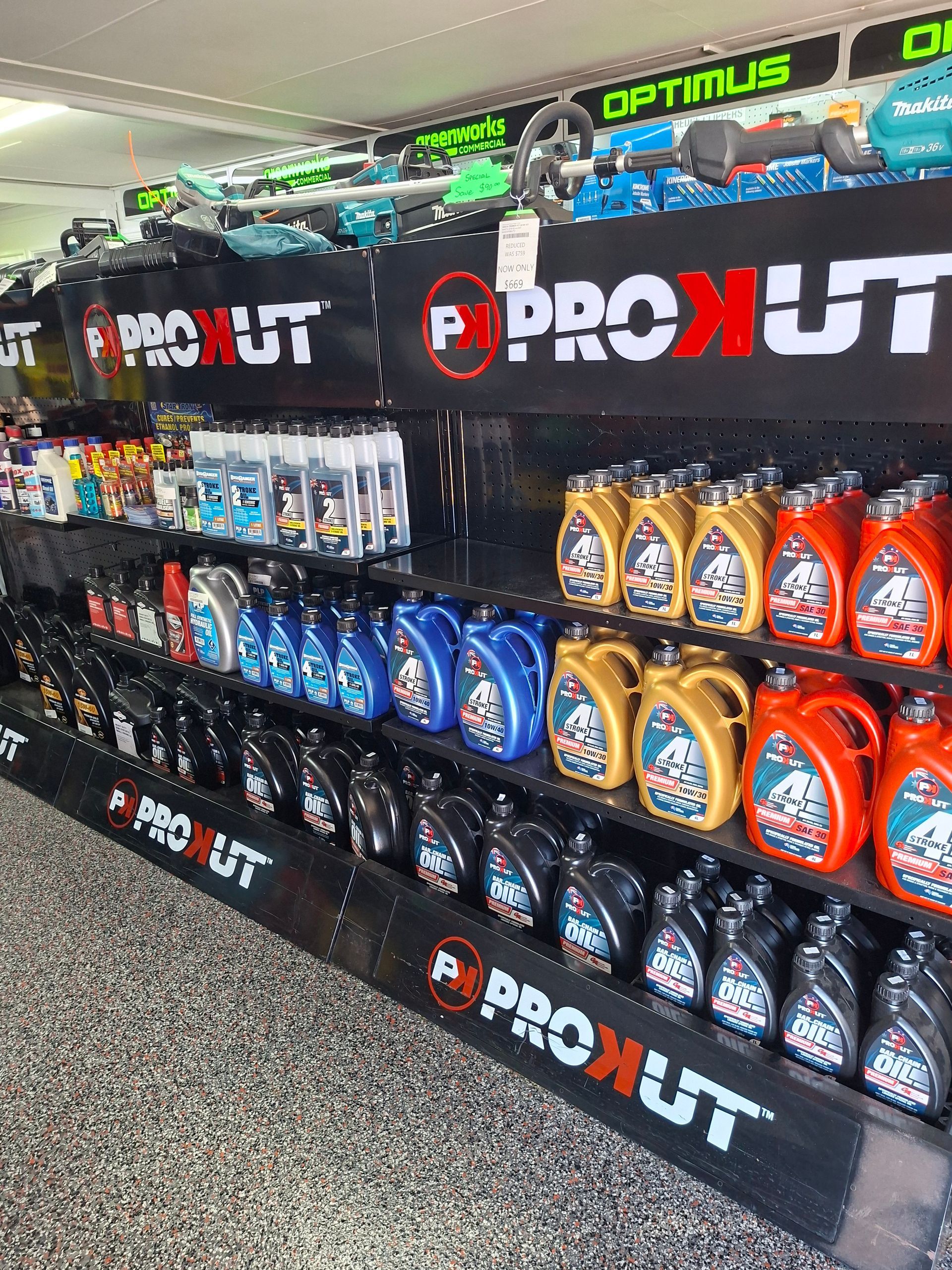 Assorted hand tools in blue and red packaging displayed on a store pegboard wall.
