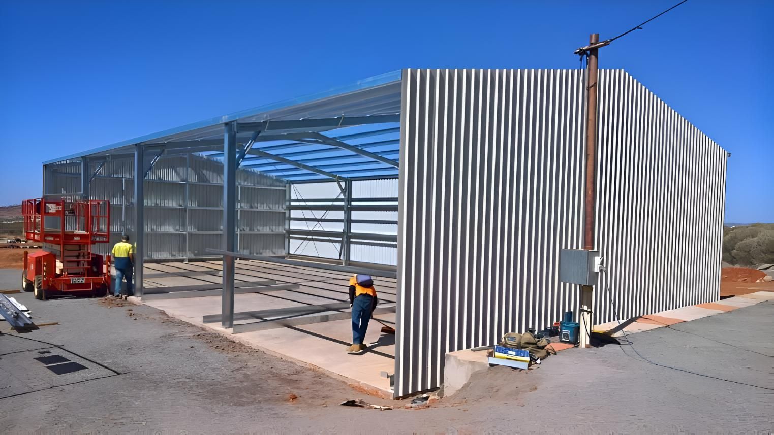 A Man Is Standing In Front Of A Building Under Construction — Alice Sheds & Structures In Ciccone, NT