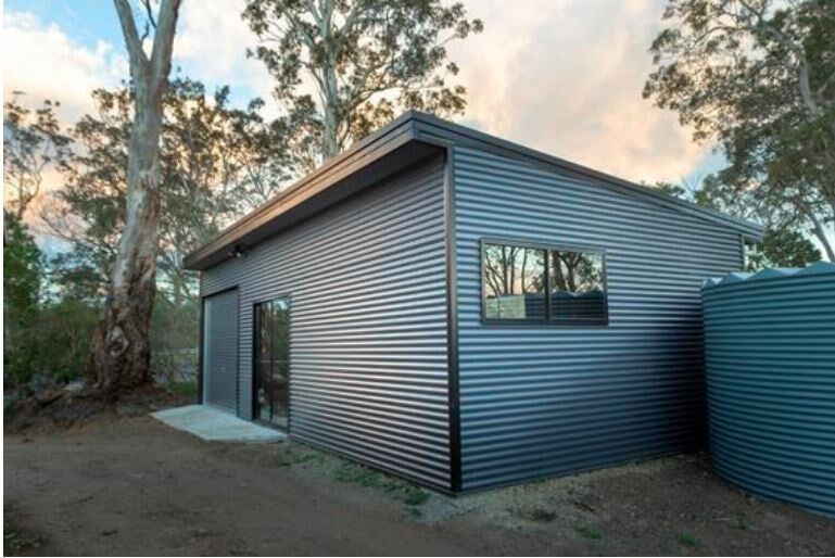 A House With A Carport In Front Of It — Alice Sheds & Structures In Ciccone, NT