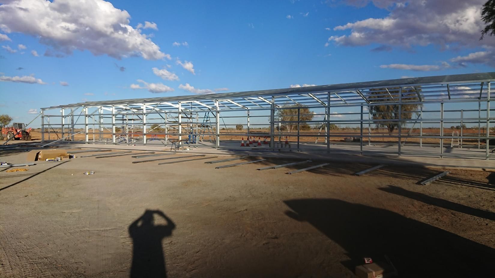 A Person Is Taking A Picture Of A Building Under Construction  — Alice Sheds & Structures In Ciccone, NT