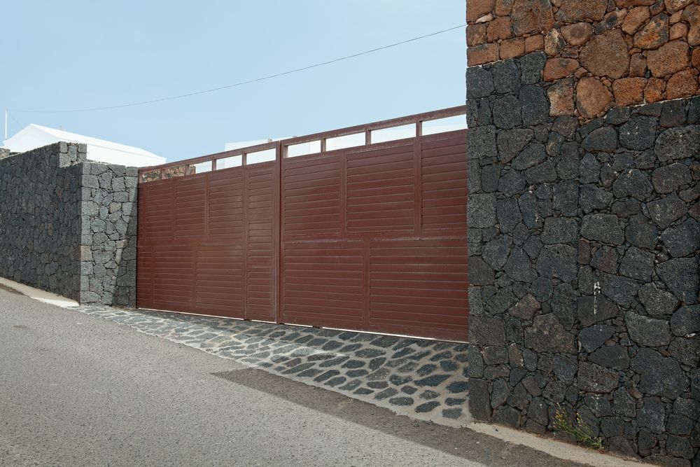 Street View of A Large Brown Metal Gate — Coastal Auto Garage Doors & Gates In North Lakes, QLD